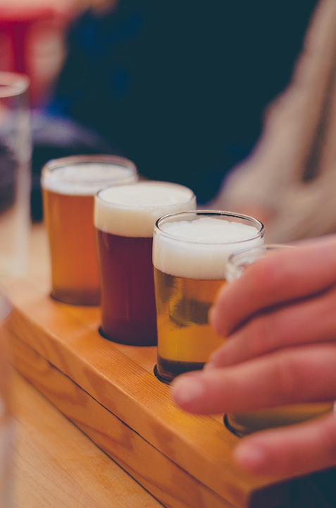 a tasting tray of small different coloured ales